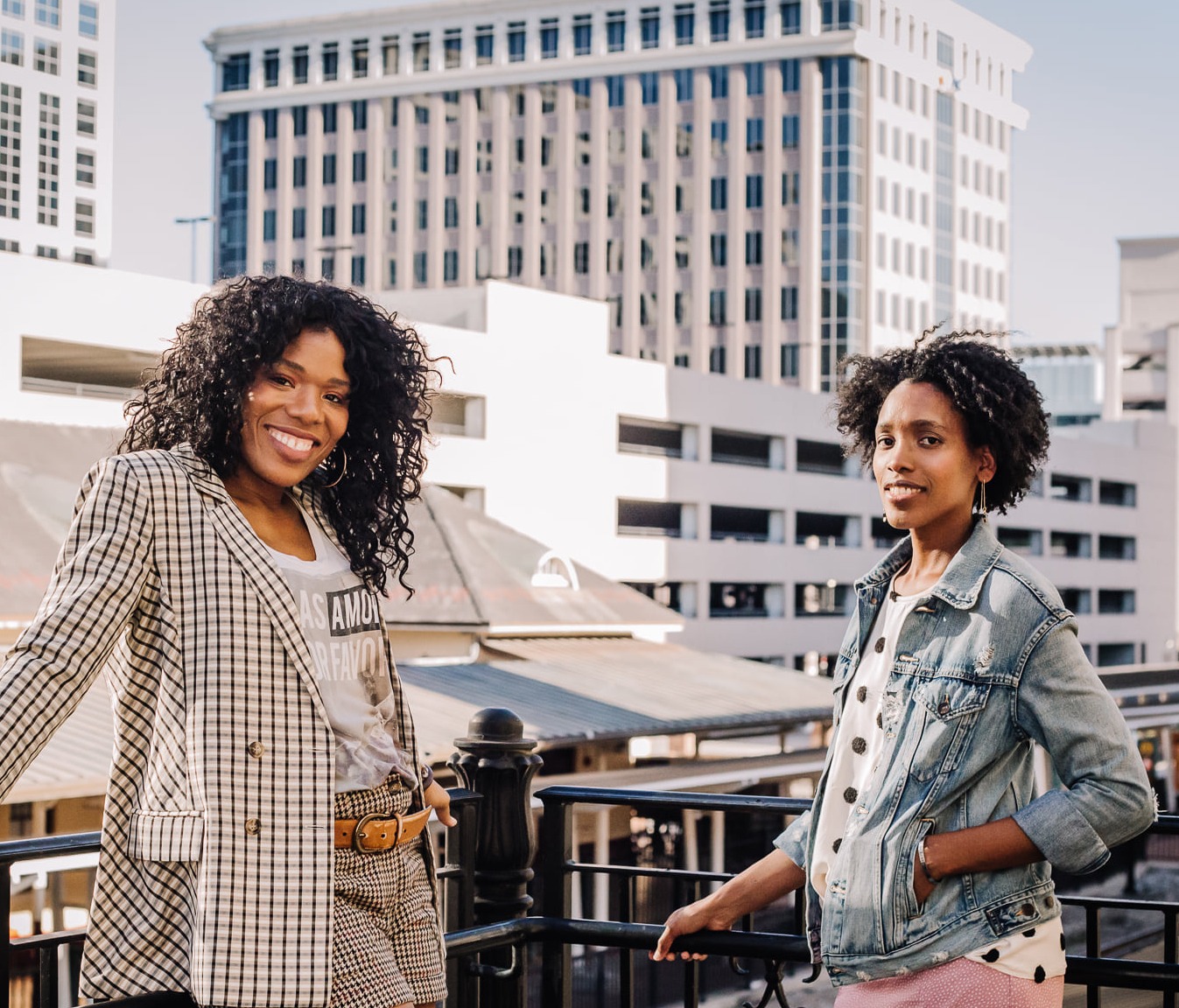 Soul Gym Founders posing together on a patio against a cityscape